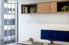 Private HALO OFFICE with adjustable-height work surface in American walnut and deep bronze. thumbnail